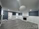 Bright and open living room features luxury vinyl plank flooring, modern recessed lighting, and a stylish fireplace at 7310 Yorkville Ct, Charlotte, NC 28273