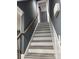 Stairway features wood handrail, white trim, and gray treads at 7310 Yorkville Ct, Charlotte, NC 28273