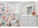 Charming bathroom with floral shower curtain, and a modern vanity at 781 Hazel Way, Denver, NC 28037