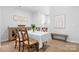 Dining room with wood table, chairs, bench and wood-look flooring in a bright, modern home at 781 Hazel Way, Denver, NC 28037