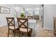 Open concept dining room adjacent to kitchen and living area, with wood-look floors at 781 Hazel Way, Denver, NC 28037
