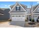 Elegant gray two-story home with a white double garage door, manicured lawn, and a welcoming entrance at 781 Hazel Way, Denver, NC 28037