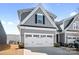 Charming gray two-story home with a white double garage door and manicured landscaping enhances curb appeal at 781 Hazel Way, Denver, NC 28037