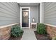 Inviting front door with wreath, stylish decor, and manicured bushes creating a welcoming entrance at 781 Hazel Way, Denver, NC 28037