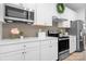Modern kitchen with stainless steel appliances, sleek cabinetry, quartz countertops, and stylish backsplash at 781 Hazel Way, Denver, NC 28037