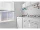 Bright laundry room featuring modern Maytag washer and dryer, ample storage and natural light from a window at 781 Hazel Way, Denver, NC 28037