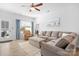 Bright living room featuring a ceiling fan, a comfortable gray sofa, and a glass door at 781 Hazel Way, Denver, NC 28037