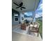 Inviting covered patio with comfortable seating, decorative rug and cooling ceiling fan at 781 Hazel Way, Denver, NC 28037