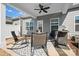 Cozy covered patio with rocking chairs, ceiling fan, and grill, perfect for outdoor entertaining and relaxation at 781 Hazel Way, Denver, NC 28037