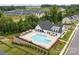 Aerial shot of the community pool surrounded by lounge chairs, cabanas, lush landscaping, and amenities at 781 Hazel Way, Denver, NC 28037