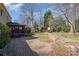 Serene backyard features a brick patio, mature trees, and a well-kept lawn at 8807 Thornbury Ln, Huntersville, NC 28078