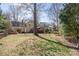 Spacious backyard with mature trees surrounding the property at 8807 Thornbury Ln, Huntersville, NC 28078