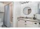 Well-lit bathroom features a vanity with granite countertops, white cabinets, and a shower with tub at 8807 Thornbury Ln, Huntersville, NC 28078
