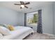 Bedroom features a ceiling fan, natural lighting, and neutral decor at 8807 Thornbury Ln, Huntersville, NC 28078