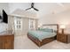 Bedroom with a tray ceiling, bedside tables, and natural lighting at 8807 Thornbury Ln, Huntersville, NC 28078