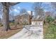 Brick home featuring a driveway leading to a 2-car garage, complemented by well-manicured landscaping and mature trees at 8807 Thornbury Ln, Huntersville, NC 28078