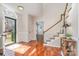 A sunlit foyer showcases gleaming hardwood floors, a staircase, and a charming arched window above the front door at 8807 Thornbury Ln, Huntersville, NC 28078