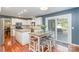 Modern kitchen with white cabinetry, granite countertops, and a spacious island with seating at 8807 Thornbury Ln, Huntersville, NC 28078