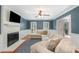 Inviting living room featuring a painted brick fireplace, hardwood floors, and stylish furnishings at 8807 Thornbury Ln, Huntersville, NC 28078