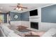 The living room features hardwood floors, a ceiling fan, a brick fireplace and a comfortable sectional sofa at 8807 Thornbury Ln, Huntersville, NC 28078