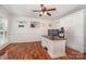 The office includes hardwood floors, a ceiling fan, and a built-in closet for storage at 8807 Thornbury Ln, Huntersville, NC 28078