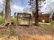 Home's backyard featuring a wooden swing set nestled between trees at 905 Kemper Cir, Rock Hill, SC 29732