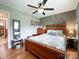 Comfortable bedroom with wooden bed frame and ceiling fan, complemented by calming green walls at 905 Kemper Cir, Rock Hill, SC 29732