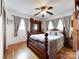 Inviting bedroom with wooden floors, ceiling fan, and a large wooden dresser with mirror at 905 Kemper Cir, Rock Hill, SC 29732