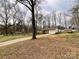 Home featuring a long driveway, an attached garage, and a well-maintained lawn, perfect for Gathering living at 905 Kemper Cir, Rock Hill, SC 29732