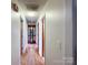 Hallway with hardwood floors, several doors, and a built-in display cabinet at 905 Kemper Cir, Rock Hill, SC 29732