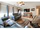 Inviting living room showcasing hardwood floors, natural light, comfortable furniture, and entertainment center at 905 Kemper Cir, Rock Hill, SC 29732