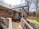 Covered patio with outdoor dining set, grill, and U.S. flags overlooking the backyard at 905 Kemper Cir, Rock Hill, SC 29732