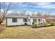 Exterior backyard view featuring an outdoor dining set and landscaping at 914 Crestmere St, Charlotte, NC 28208