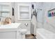 Well-lit bathroom featuring marble-style walls, a modern vanity, and stylish shower curtain at 914 Crestmere St, Charlotte, NC 28208