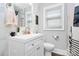 Bright bathroom features marble walls, white vanity, and a window providing natural light at 914 Crestmere St, Charlotte, NC 28208