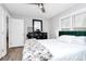 Well-lit bedroom features hardwood floors, a dresser with a mirror, and natural light at 914 Crestmere St, Charlotte, NC 28208