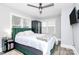 Cozy bedroom features a green upholstered bed, dark armoire, and natural light at 914 Crestmere St, Charlotte, NC 28208