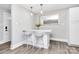 Dining area with two barstools, lighting pendants and a mirror over white breakfast bar with vinyl floors at 914 Crestmere St, Charlotte, NC 28208