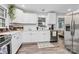 Modern kitchen boasts white cabinets, stainless steel appliances, and ample counter space at 914 Crestmere St, Charlotte, NC 28208