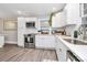 Updated kitchen features stainless steel appliances, white cabinets, and a tiled backsplash at 914 Crestmere St, Charlotte, NC 28208