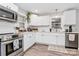 Bright kitchen features white cabinets, stainless steel appliances, and subway tile backsplash at 914 Crestmere St, Charlotte, NC 28208
