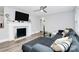Inviting living room features a modern fireplace, stylish sectional sofa, and sleek hardwood flooring at 914 Crestmere St, Charlotte, NC 28208