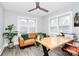 Bright home office with hardwood floors, a comfortable leather couch, and a ceiling fan at 914 Crestmere St, Charlotte, NC 28208