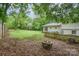 Large backyard with a fire pit, lawn and privacy fence, perfect for entertaining at 917 Bobby Ln, Charlotte, NC 28211