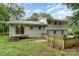 Exterior backyard featuring an outdoor patio, lawn, landscaping, and surrounding trees at 917 Bobby Ln, Charlotte, NC 28211