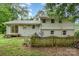 Backyard of home with fencing, some landscaping, and a small deck near the house at 917 Bobby Ln, Charlotte, NC 28211