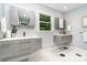 Modern bathroom with floating vanities, hexagon tile flooring, and a bright window at 917 Bobby Ln, Charlotte, NC 28211