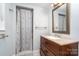 Charming bathroom features a neutral color scheme, shower with curtain, and vanity at 917 Bobby Ln, Charlotte, NC 28211