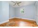 Light-filled bedroom with hardwood floors, a ceiling fan, and closet at 917 Bobby Ln, Charlotte, NC 28211