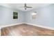 Bright bedroom with hardwood floors, two windows, and ceiling fan at 917 Bobby Ln, Charlotte, NC 28211
